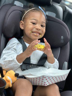 My daughter with all the icing on her mouth from her Smiley Face Cookie