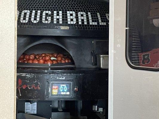 Fire roasting their tomatoes in the morning to prepare their sauce for the day...