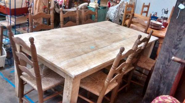 This is a handcrafted farm table with eight matching chairs