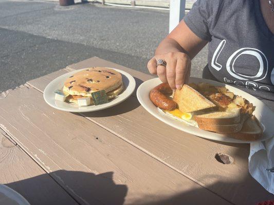 Big breakfast with a stack of blueberry pancakes on the side...