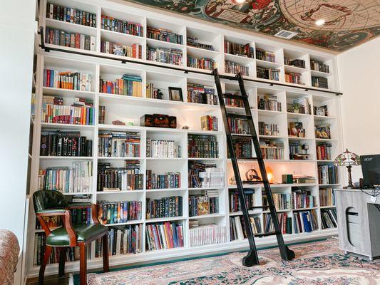 Custom shelving with a sliding ladder for magical home library.