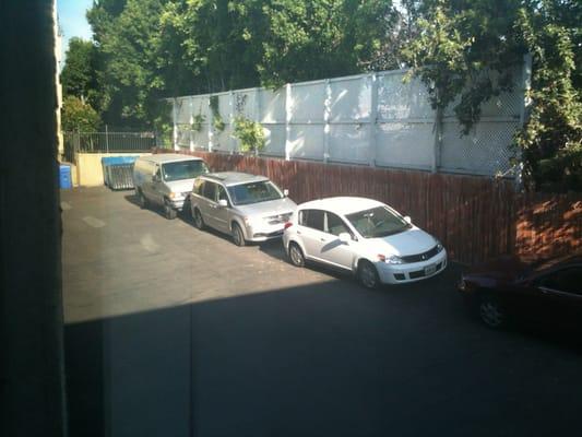 Free parking along fence. Also assigned parking under the building.