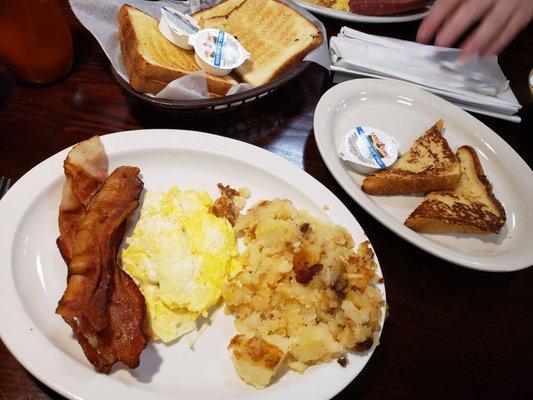 2 eggs, bacon, potatoes, toast, and a side of French toast.