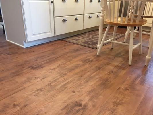 Wood look vinyl plank flooring is a perfect compliment to this kitchen design.