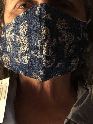 Vera Bradley bandanna print mask looks good. A little big for my wife but fits me just fine. Has a pocket for inserting a filter.