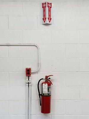 Fresh fire extinguisher installed with a sign.