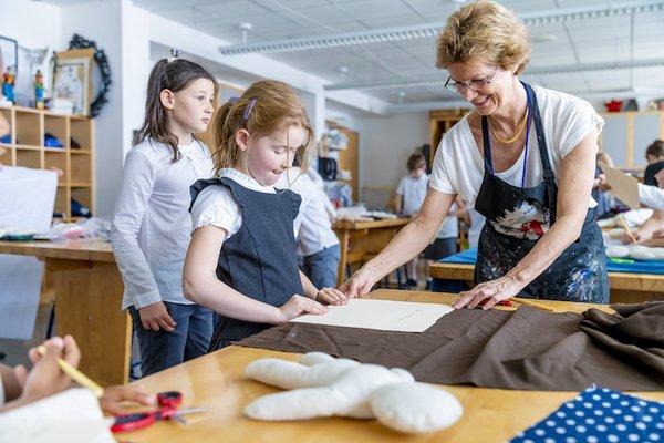 Elementary art classes foster creativity in many media, from drawing to painting to sculpture and here, sewing.