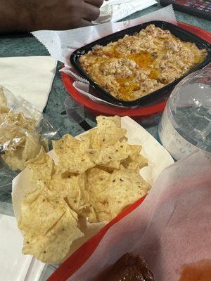 Sausage dip with tortilla chips.