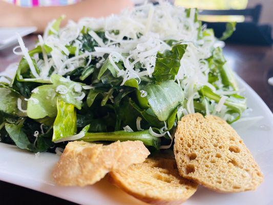 Black kale served with manchego cheese and creamy citrus dressing