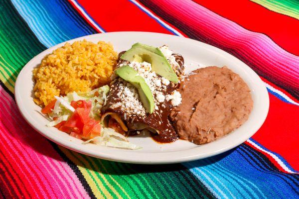 Our delicious Mole Enchilada Plate. Two pulled chicken enchiladas topped with our homemade Mole sauce. Served with rice and beans.