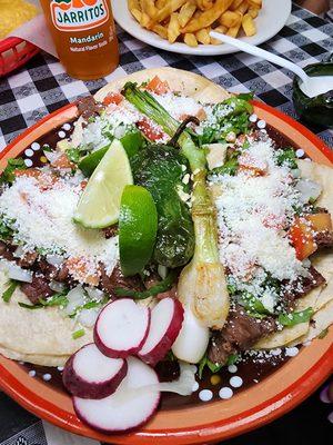 Tacos Asada added cheese, tomatoes, and sour cream on the side