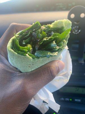 Spinach wrap with spinach black olives yellow peppers red onions vegan mayo black bean spread and mustard yummy