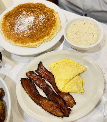 Pancake, eggs, bacon and grits