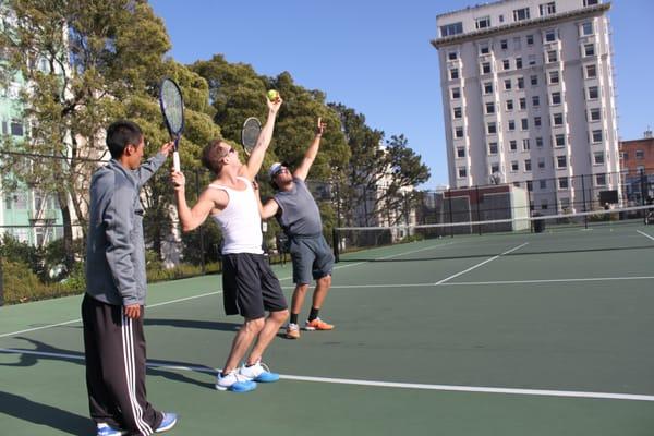 Demonstrating trophy position on the serve.