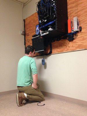 Technician Eric troubleshooting a faulty security feed on location