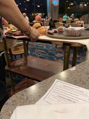 Server brings food in old folks home cart.