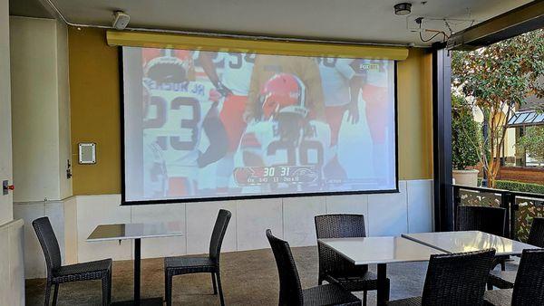 live NFL game via the outdoor screen projector of the cinema