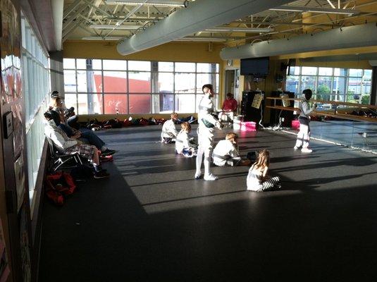 Students practice while parents watch.