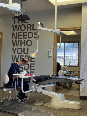 The dentist with my son, no cavities this time! Notice the sign behind. The world needs who you were made to be.