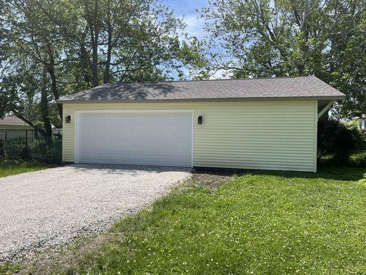 Our finished garage!  (Coach lights not included.) Bullock also used the same shingles on new garage that are on our home.  Nice touch!