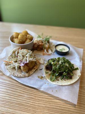 Thai chicken, asada zing & tempura shrimp tacos with tots & queso