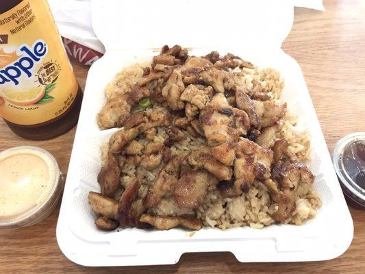 Chicken with fried rice side of yummy sauce and teriyaki sauce