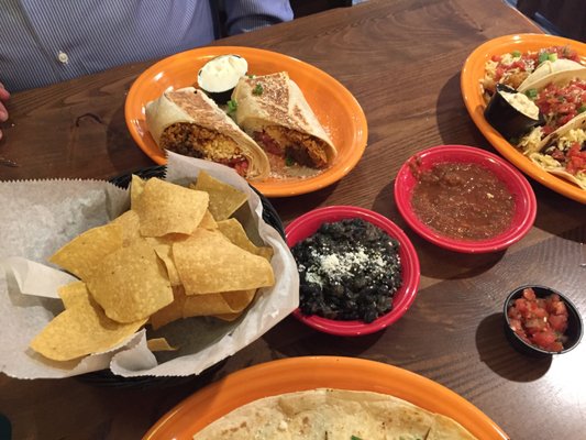 Tortilla chips, black beans, salsa, beef burrito.