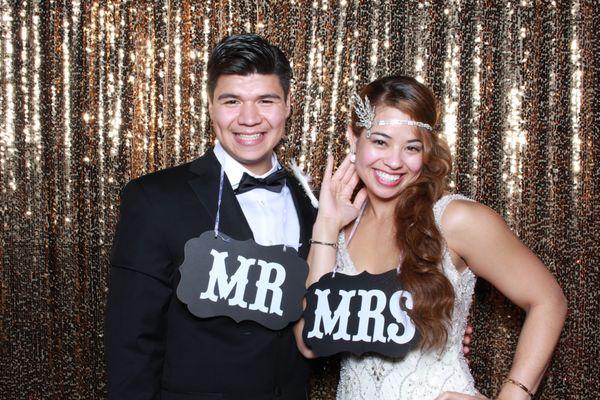 Newlyweds showing off for the photo booth