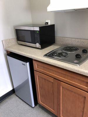 Kitchen comes with mini fridge, microwave and cooktop.