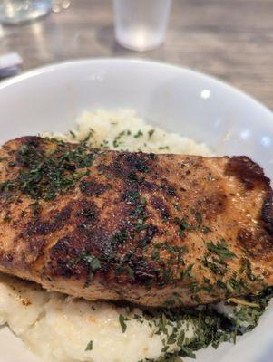 Seared salmon on grits.