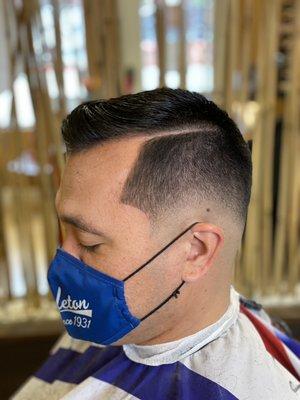 Low bald fade combover with hard part.