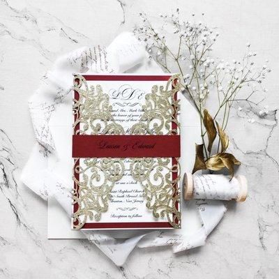 A Christmas inspired, gold and red laser cut wedding invitation suite.