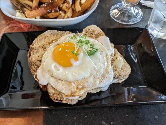 Bacon and Swiss cheese between tangy sourdough bread, topped with a runny fried egg and maple mustard /  bechamel sauces.