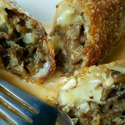 Cheese Steak Egg Rolls. We make these here fresh combined with our Sriracha Cheddar sauce, could be why they're so popular.