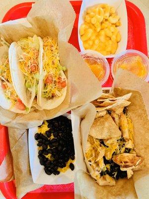 My fam's spread. Top (L to R): 3 Chicken Tacos; Kids Mac and Cheese with side of fruit; Sante Fe Bowl; Side of Rice and Beans.