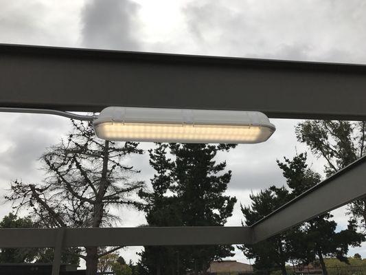 New carport vapor tied weather  proof light fixture for new metal parking area.