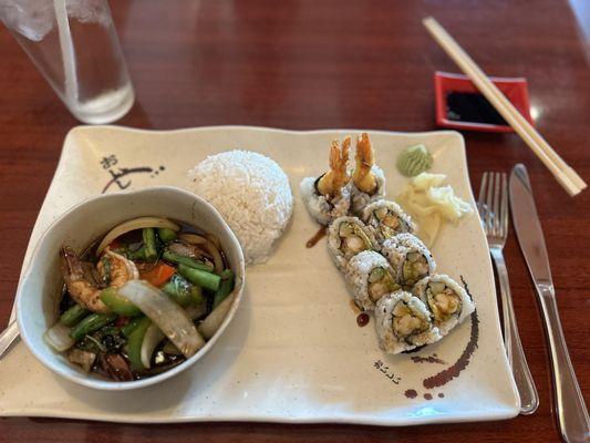 Shrimp tempura roll and shrimp with mixed vegetables in a spicy brown sauce.