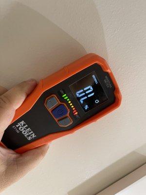 Detecting heavy moisture collection in bathroom wall via the utilization of a moisture meter. Possible mold infestation can ensue.