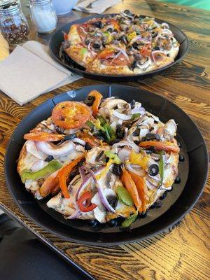 Veggie pizza with chicken, wings and salad.