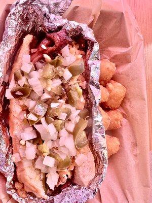 Buffalo Dog with jalapeños and onions paired with tots