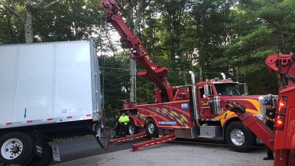 Tow truck and crew in action