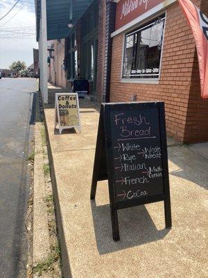 along sidewalk near front entrance to shop