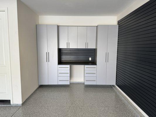 Floor, cabinets/workbench, and slatwall installation.