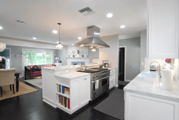 An open kitchen flows perfectly into the dining and living room. Dark hardwood floors remain throughout the home.