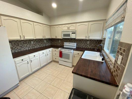 Kitchen butcher block counter tops, backsplash,painted cabinets,new hardware and recessed lighting