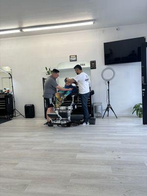 Getting a cut at the new shop, the owner Luis