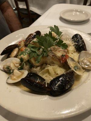 Mussels, clams and assorted seafood in a white wine sauce with fresh papardella pasta