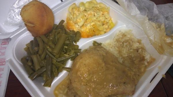 Smothered pork chop with rice and green beans & mac and cheese.