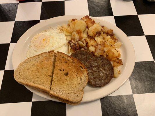 Breakfast, eggs sausage home fries and toast.