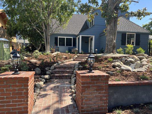 Brick wall and river rock bed